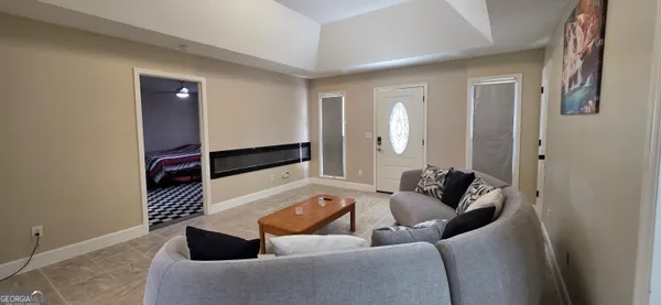 a living room with furniture and a gate