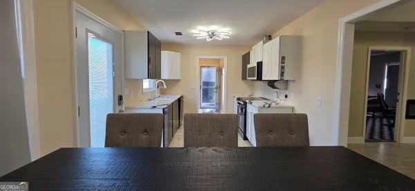 a view of kitchen with cabinets and wooden floor