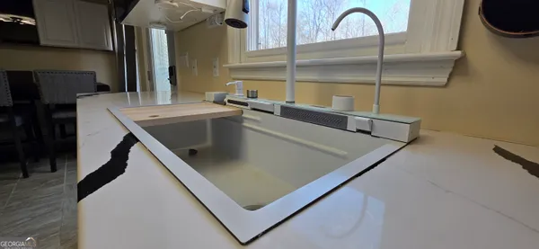 a view of a room with furniture and a window