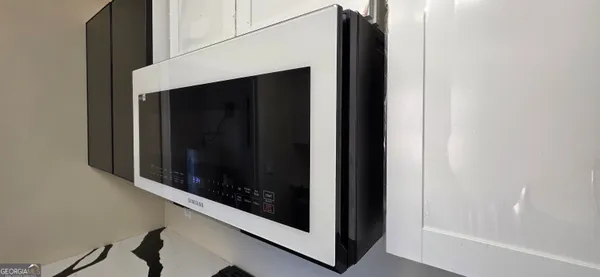 a bedroom with a bed and a wooden floor