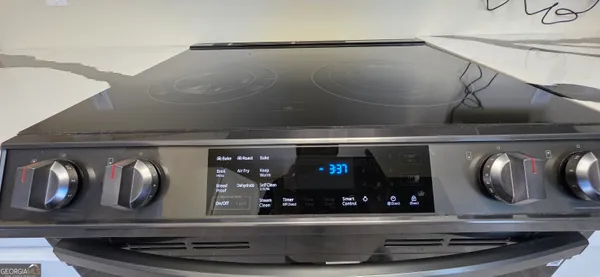 a bedroom with bed and a flat tv screen