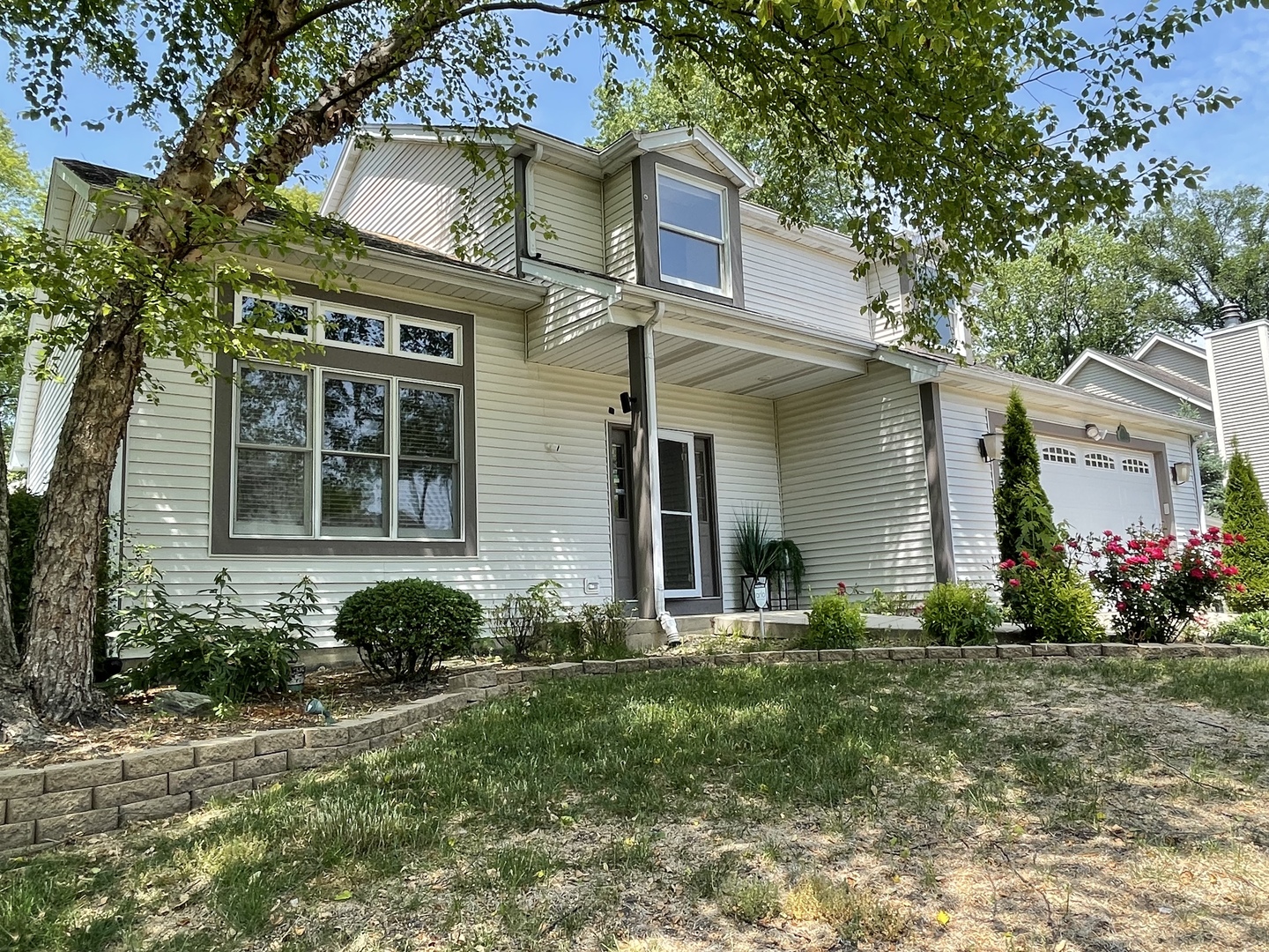 298 10th Street Wheeling, IL 60090 - Photo 1 of 22 a view of a house with a yard and plants