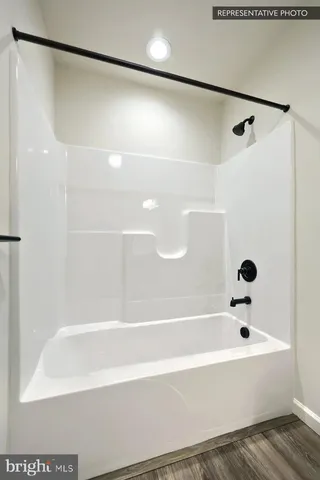 a bathroom with a shower and a bath tub