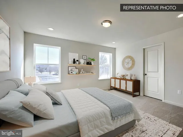 a bedroom with a large bed and a window