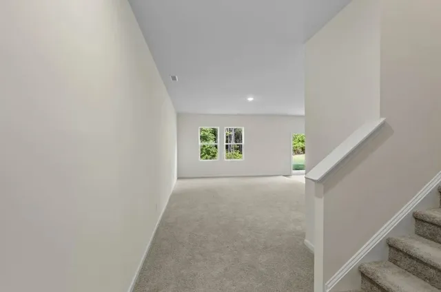 a living room with furniture and a kitchen
