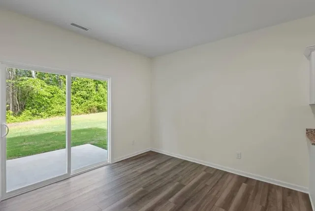 a view of an empty room and wooden floor
