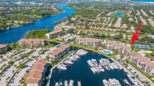 an aerial view of residential houses with outdoor space and trees