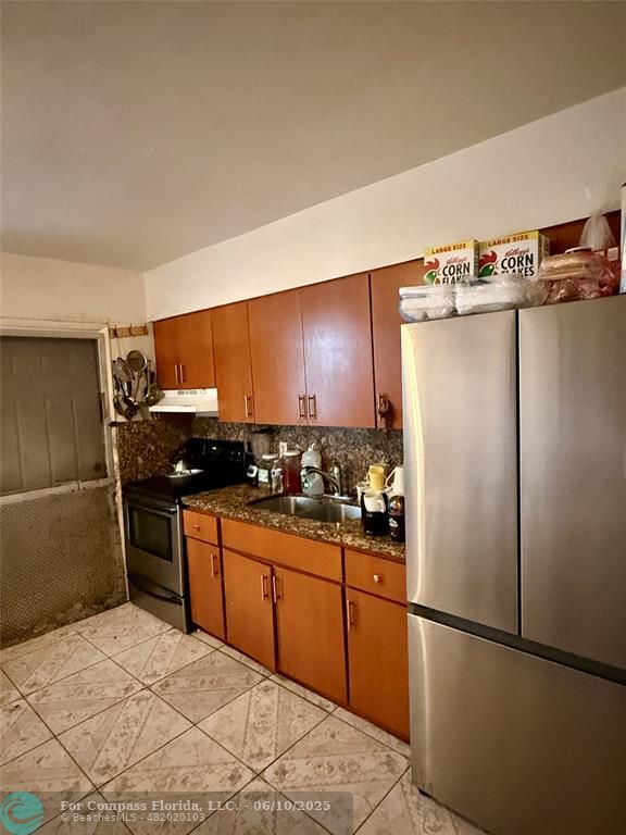 430 Northeast 75th Street Miami, FL 33138 - Photo 11 of 11 a kitchen with stainless steel appliances a refrigerator and a sink