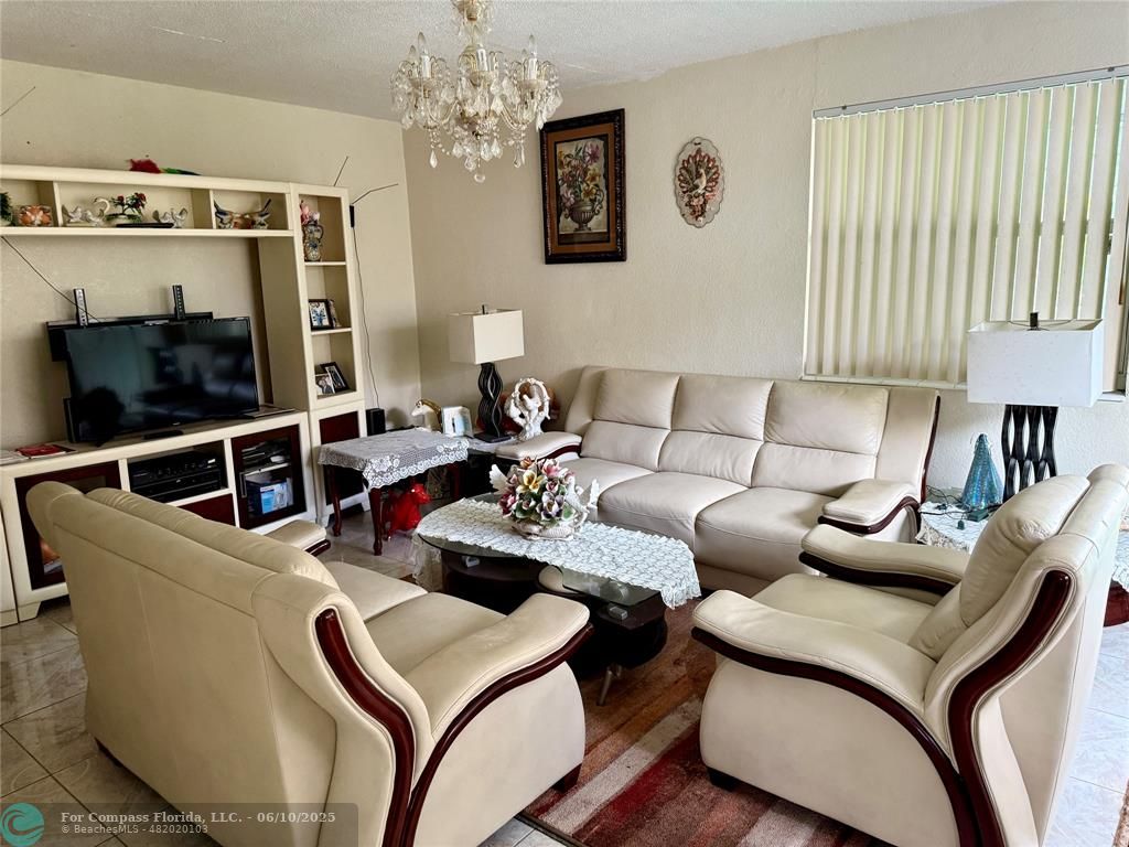 430 Northeast 75th Street Miami, FL 33138 - Photo 8 of 11 a living room with furniture and a flat screen tv