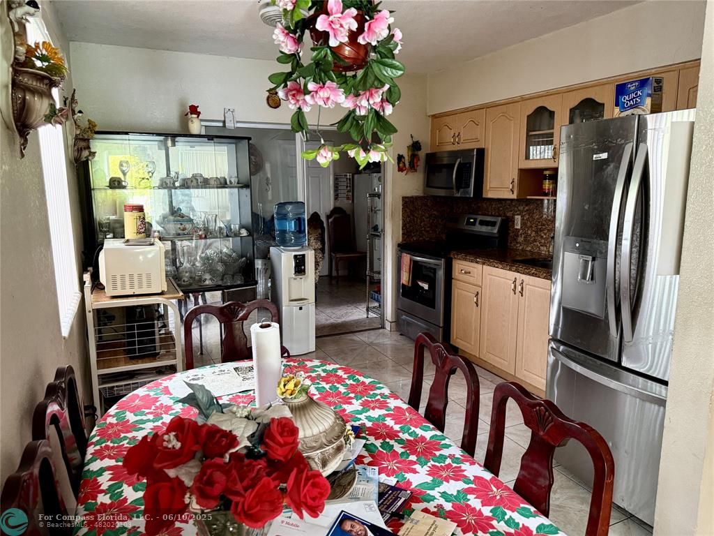 430 Northeast 75th Street Miami, FL 33138 - Photo 9 of 11 a kitchen with granite countertop a refrigerator and a stove
