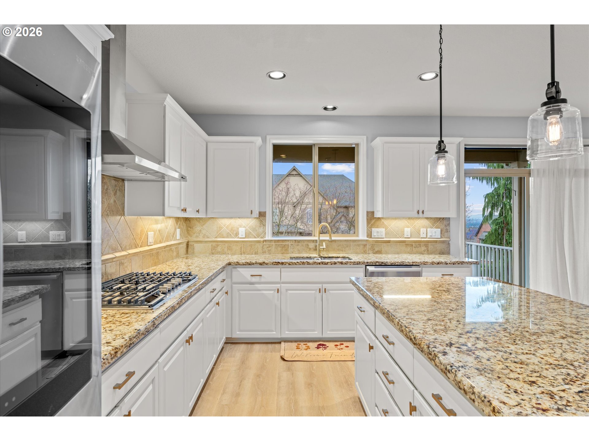 12059 Southwest Stringer Lane Tigard, OR 97224 - Photo 11 of 41 a kitchen with stainless steel appliances granite countertop a sink and cabinets