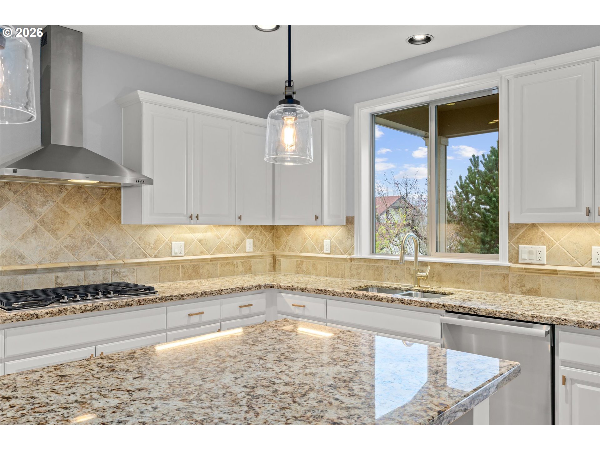 12059 Southwest Stringer Lane Tigard, OR 97224 - Photo 13 of 41 a kitchen with a stove a sink and a counter top space