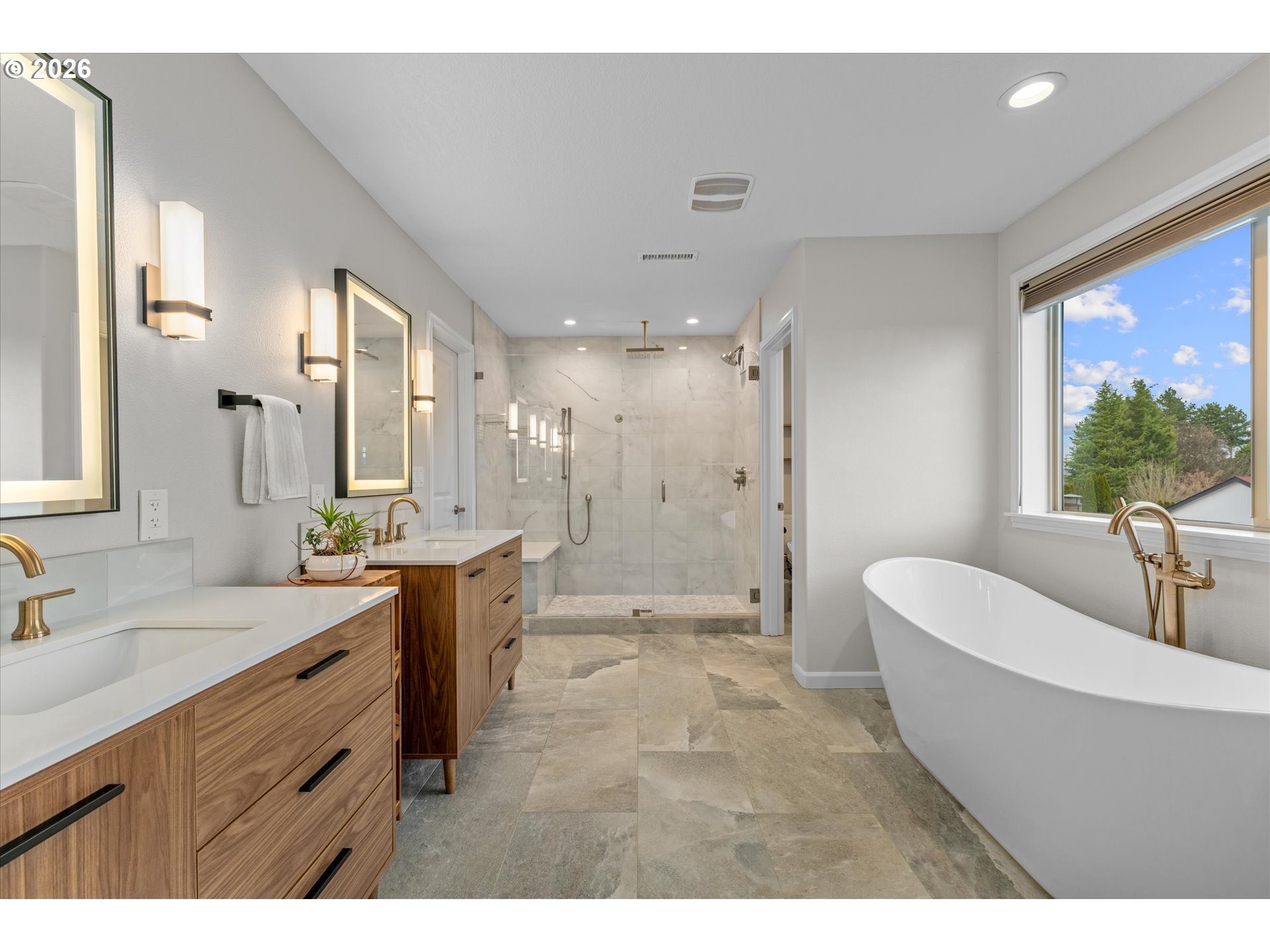 12059 Southwest Stringer Lane Tigard, OR 97224 - Photo 14 of 41 a bathroom with a double vanity sink a large mirror a bathtub and shower