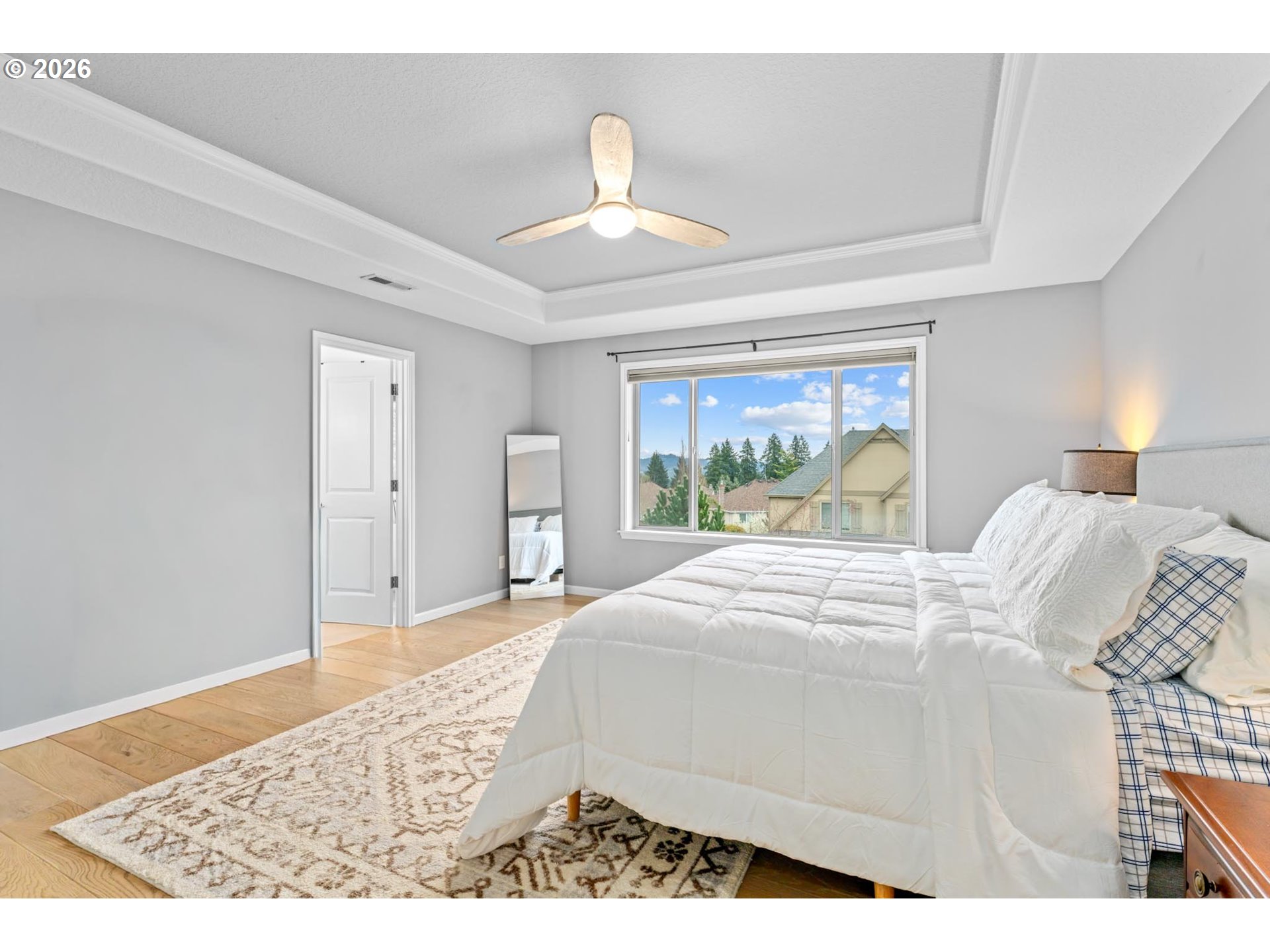 12059 Southwest Stringer Lane Tigard, OR 97224 - Photo 21 of 41 a bedroom with a bed and a large window