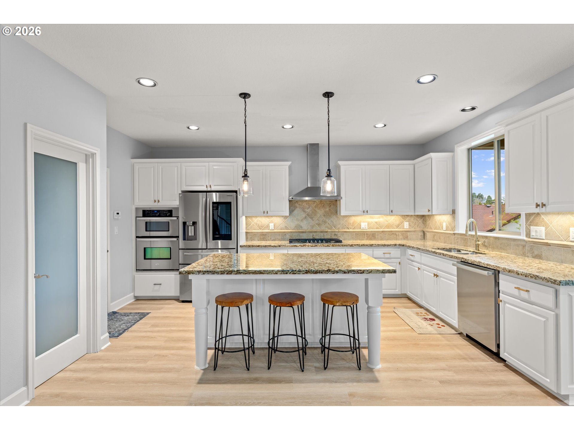 12059 Southwest Stringer Lane Tigard, OR 97224 - Photo 9 of 41 a kitchen with stainless steel appliances granite countertop wooden floor sink and stove