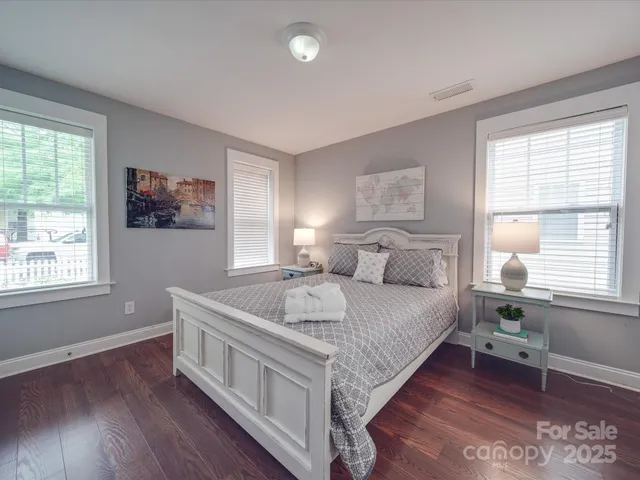 a spacious bedroom with a bed and a window