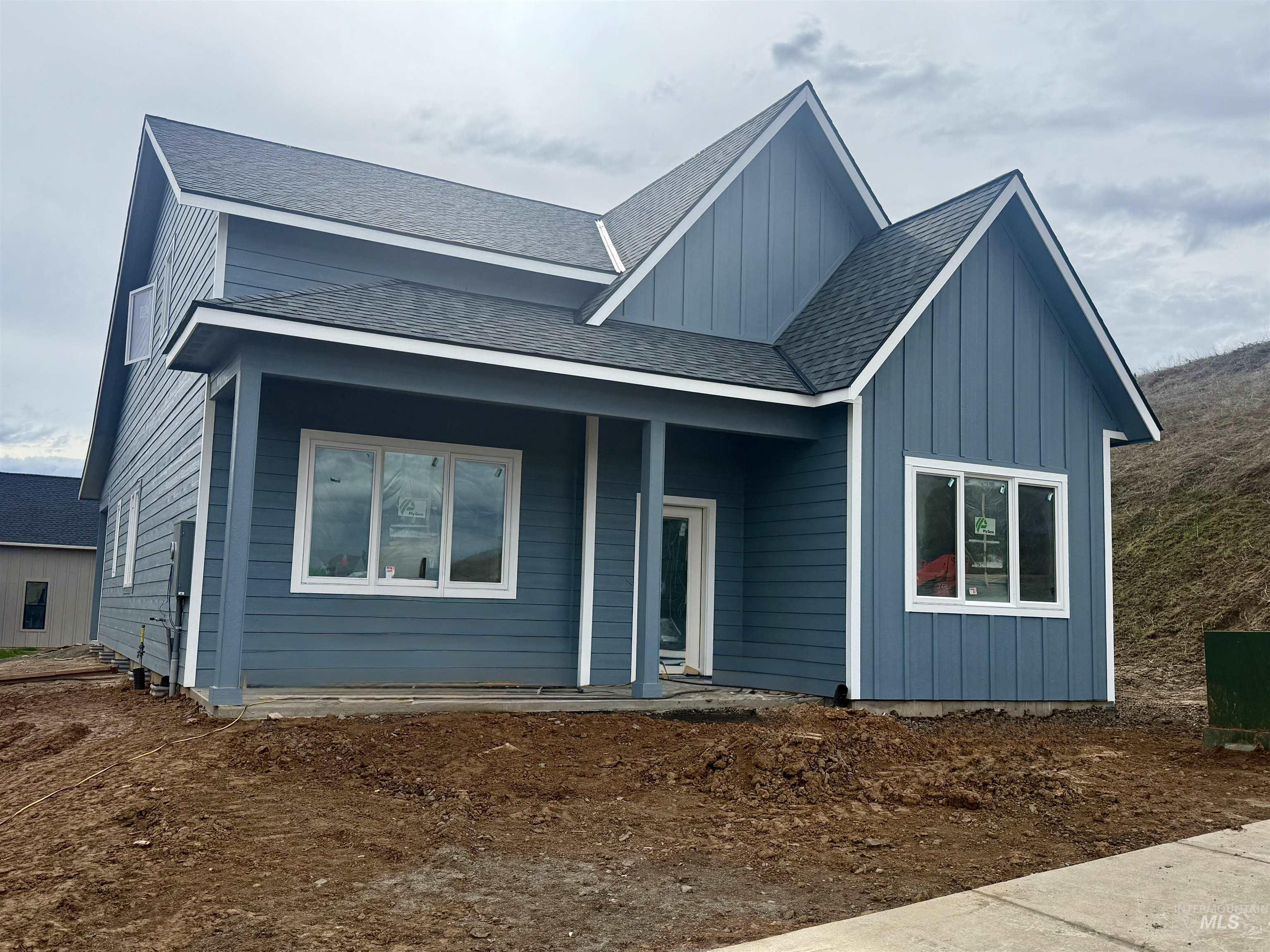 View of front of property featuring board and batten siding and a shingled roof