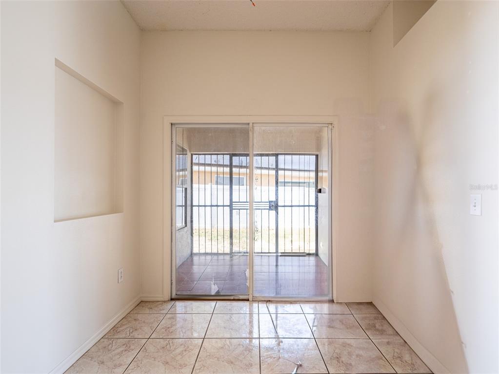 6569 Long Breeze Road Orlando, FL 32810 - Photo 12 of 31 a view of an empty room and window