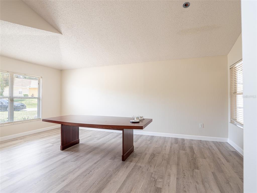 6569 Long Breeze Road Orlando, FL 32810 - Photo 13 of 31 a room with furniture and windows