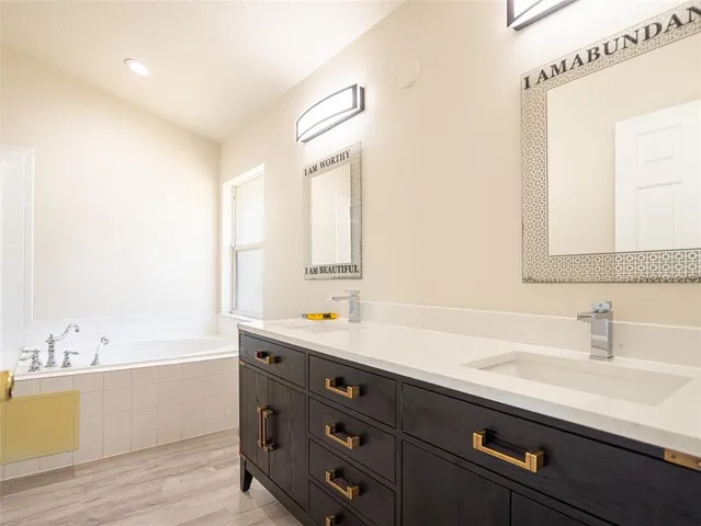 a view of a bathroom with a tub and sink