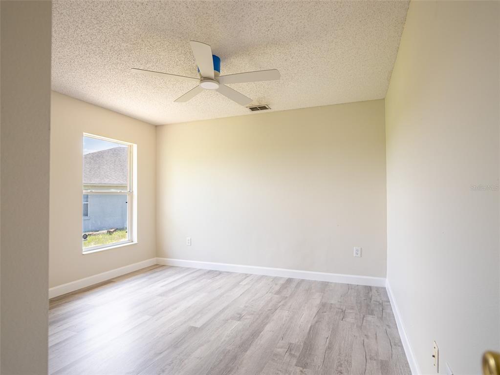 6569 Long Breeze Road Orlando, FL 32810 - Photo 18 of 31 an empty room with a empty space and windows