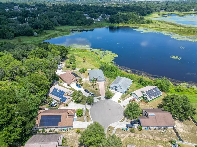 an aerial view of a house with a lake view