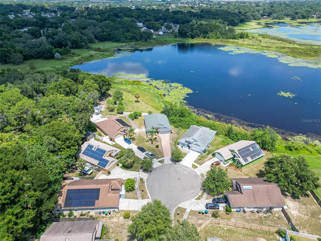 6569 Long Breeze Road Orlando, FL 32810 - Photo 2 of 31 an aerial view of a house with a lake view
