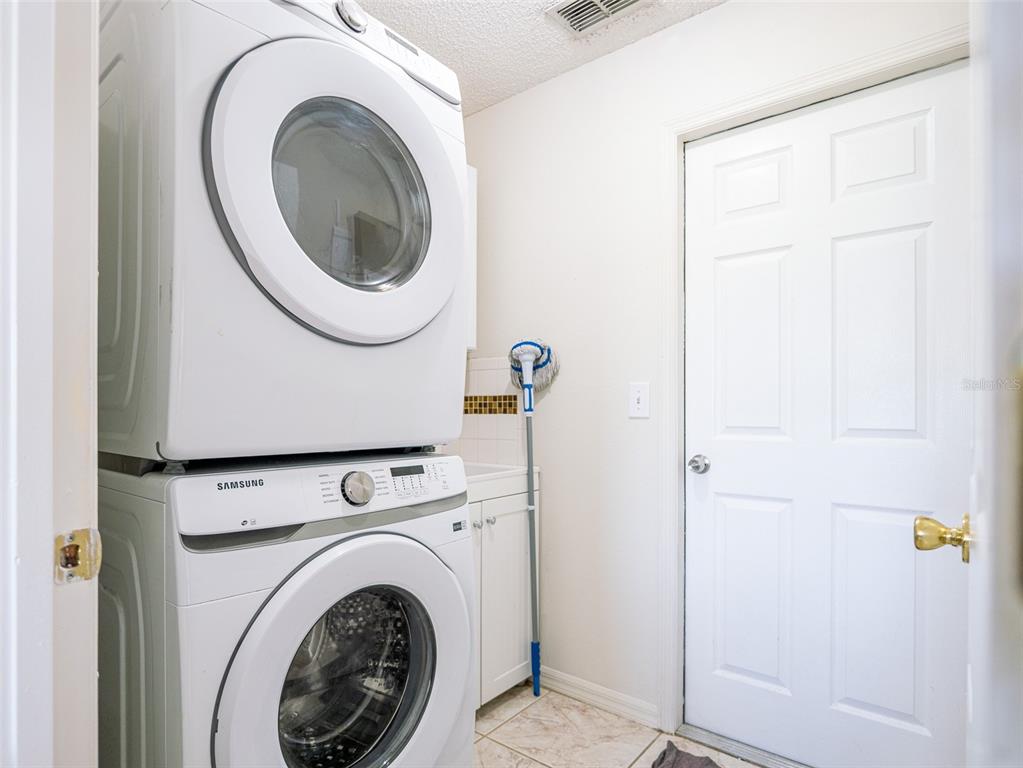 6569 Long Breeze Road Orlando, FL 32810 - Photo 27 of 31 a view of a hallway with washer and dryer