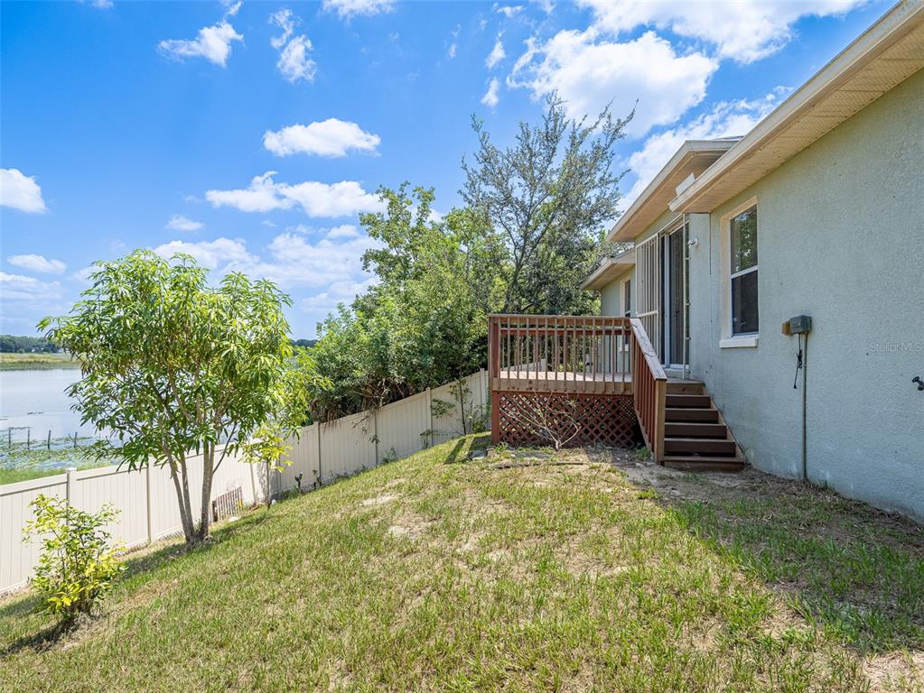 6569 Long Breeze Road Orlando, FL 32810 - Photo 28 of 31 a view of a house with a yard
