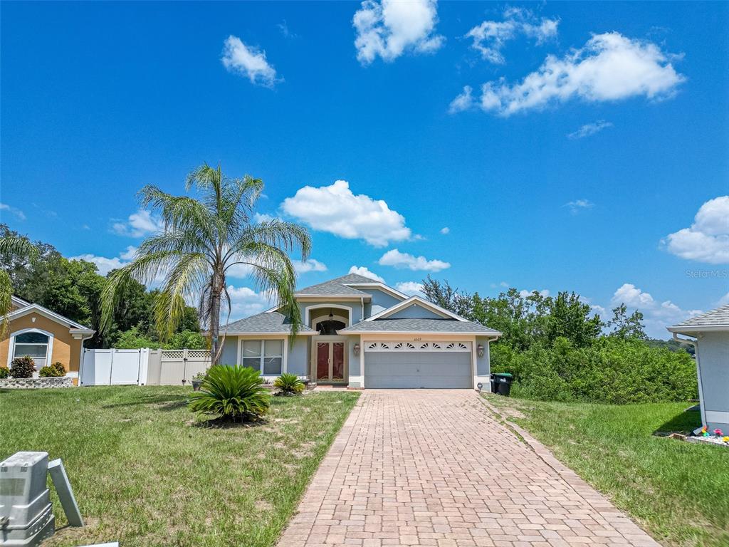 6569 Long Breeze Road Orlando, FL 32810 - Photo 29 of 31 a front view of a house with a yard
