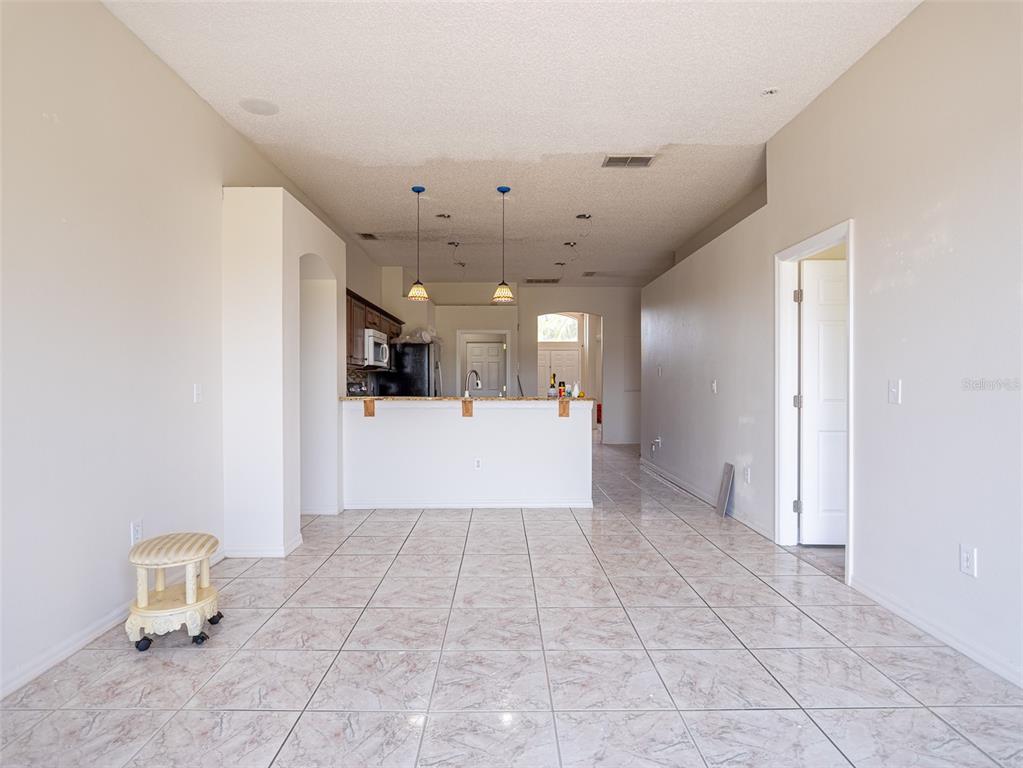 6569 Long Breeze Road Orlando, FL 32810 - Photo 4 of 31 a view of a livingroom with a kitchen