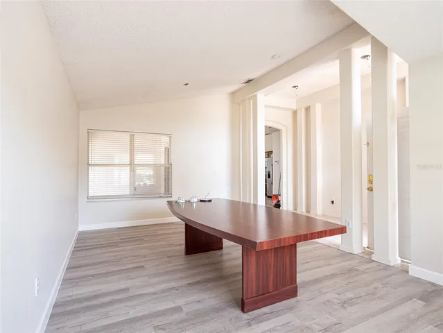 a room with wooden floor and front door