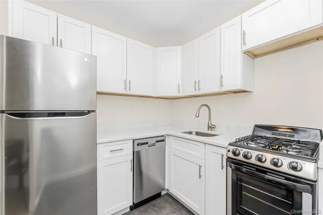 a white refrigerator freezer sitting inside of a kitchen