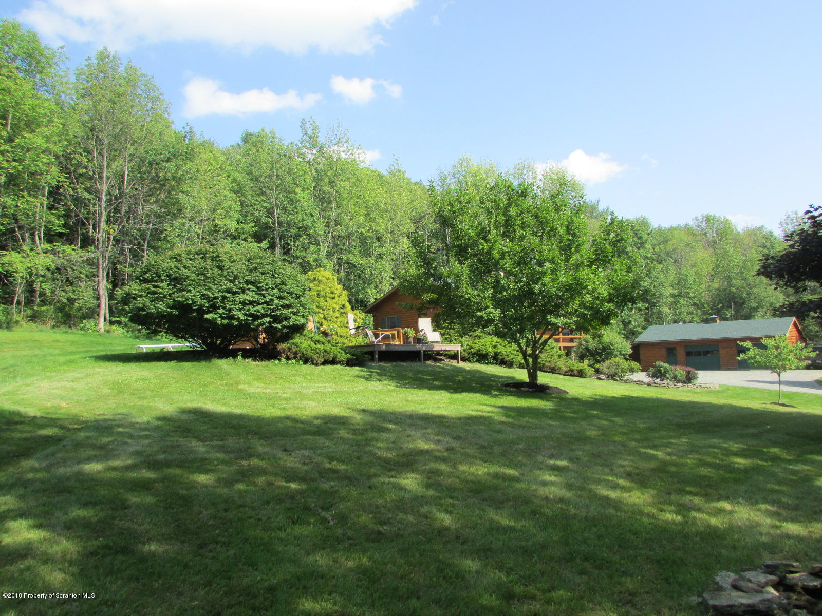 266 Brown Road Montrose, PA 18801 - Photo 43 of 47 a backyard of a house with lots of green space and fountain