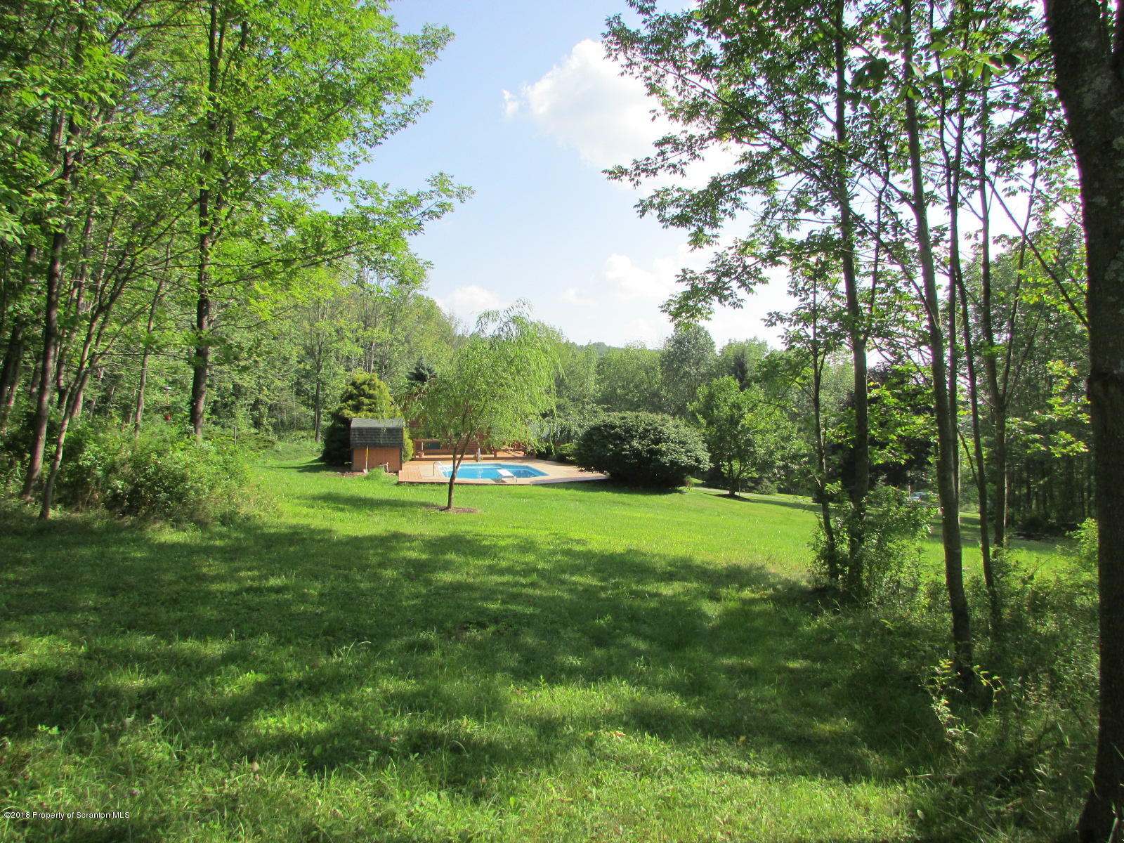 266 Brown Road Montrose, PA 18801 - Photo 45 of 47 a view of a grassy field with trees in the background