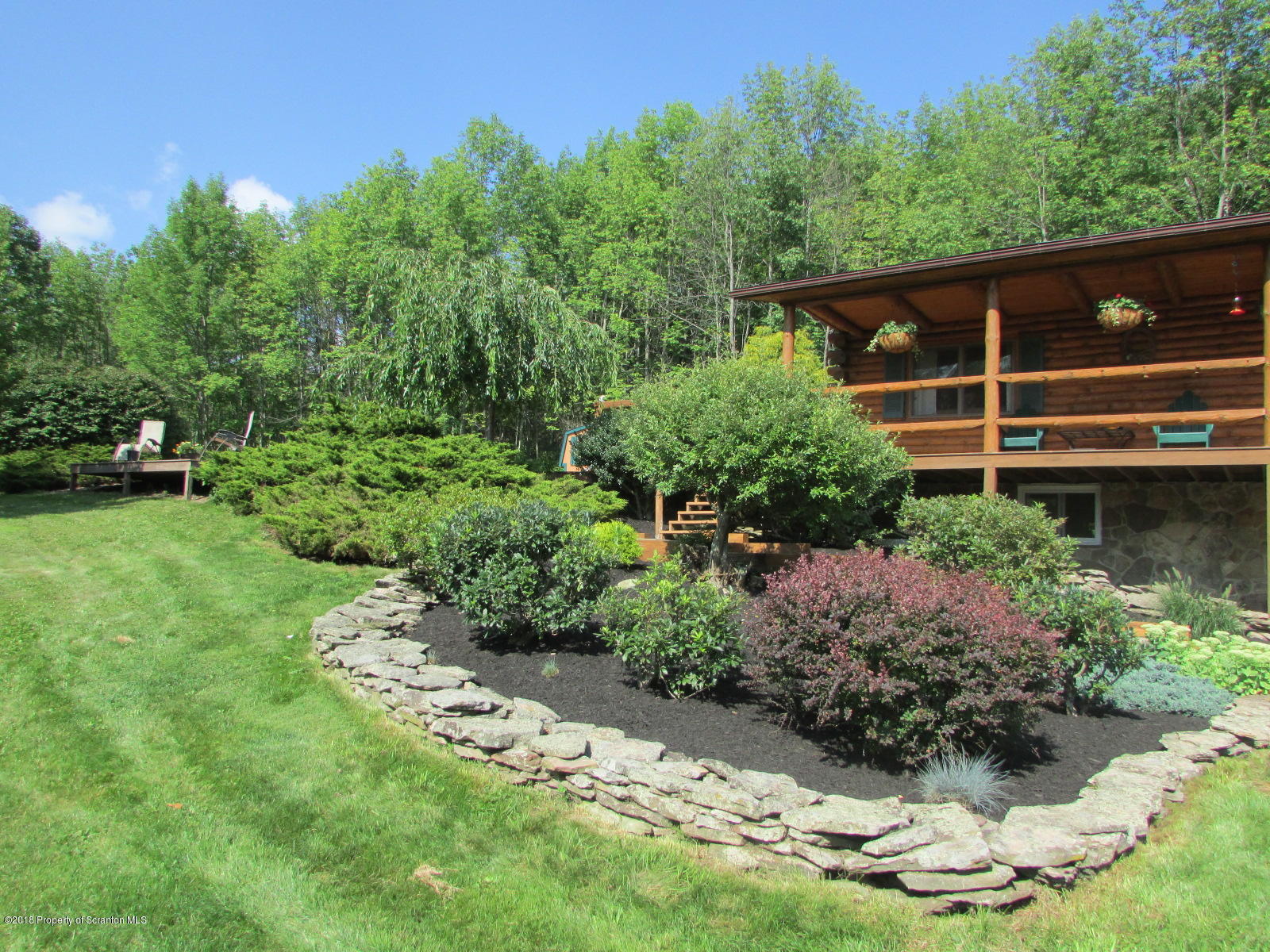 266 Brown Road Montrose, PA 18801 - Photo 7 of 47 a backyard of a house with a yard and outdoor seating