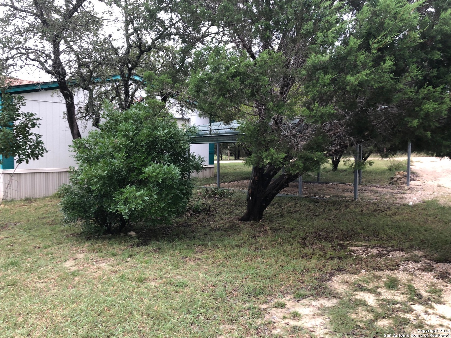 403 Los Indios Road Boerne, TX 78006 - Photo 6 of 21 a view of a house with a tree in the yard