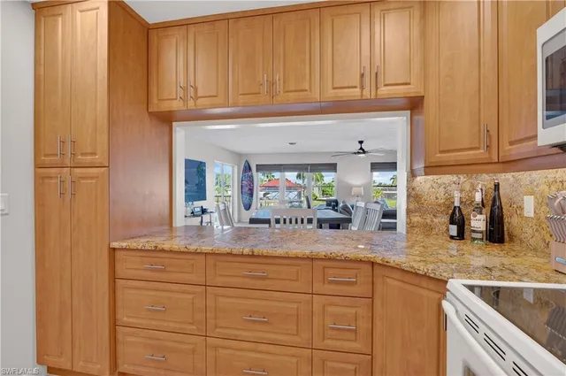 a kitchen with granite countertop stainless steel appliances sink and cabinets