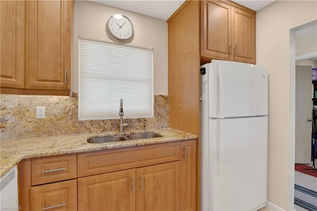 a bathroom with a sink and a refrigerator