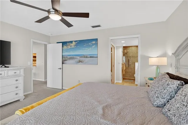 a bedroom with a bed and a flat tv screen on dresser