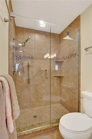 a bathroom with a glass shower door