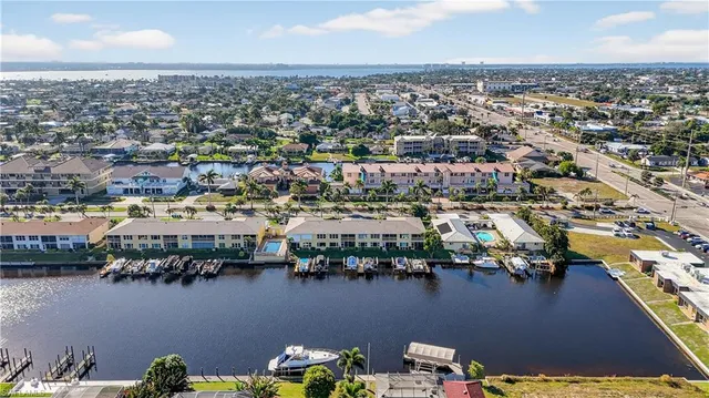 an aerial view of residential building and lake