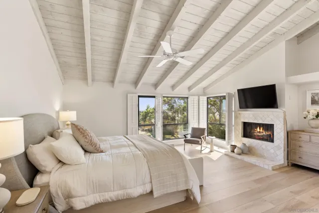 a spacious bedroom with a bed and a fireplace