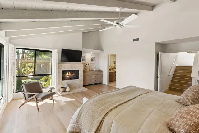 a bedroom with a bed and a fireplace