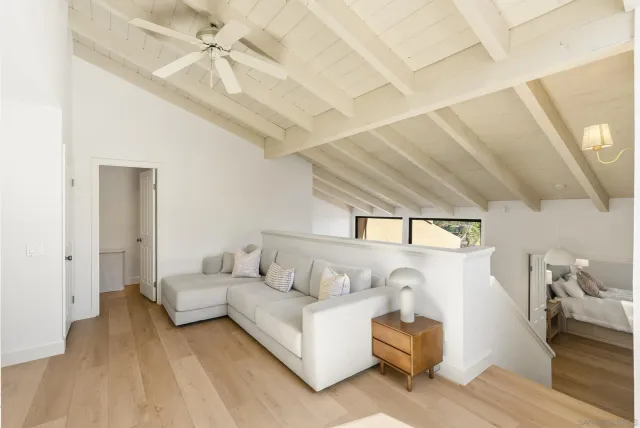 a living room with furniture and a ceiling fan
