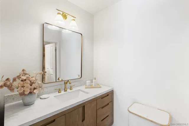 a bathroom with a sink vanity and mirror