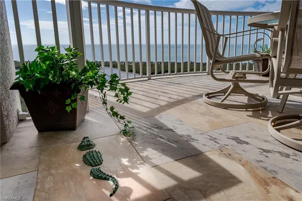 a balcony with a potted plant