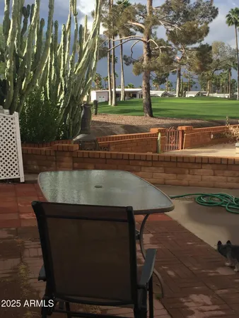 a view of a yard with a table and chairs