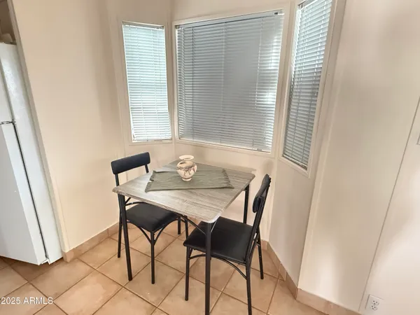 a view of a dining room with furniture and a window