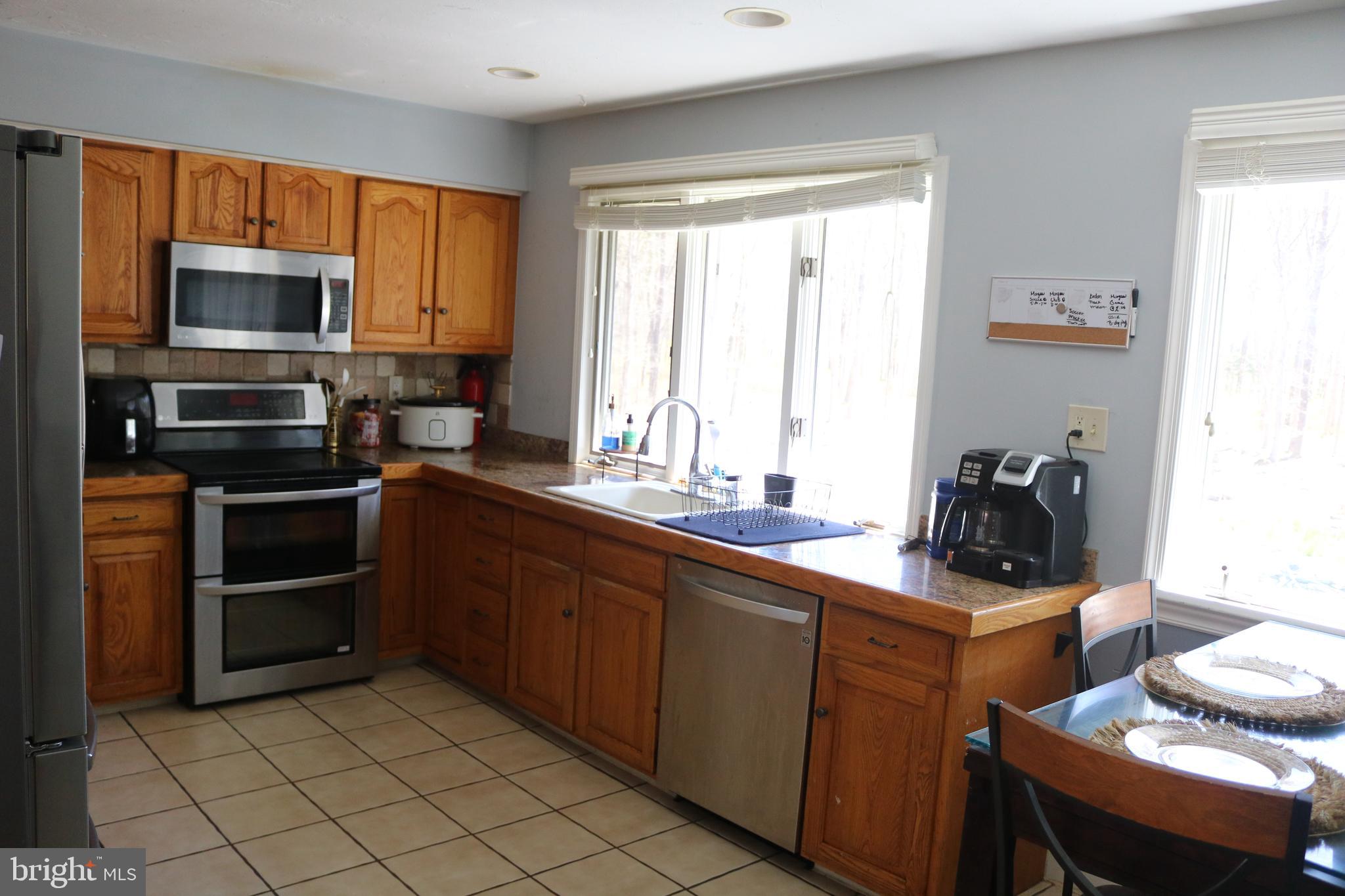 770 Whitehall Road Newfield, NJ 08344 - Photo 23 of 56 a kitchen with stainless steel appliances a stove sink and microwave
